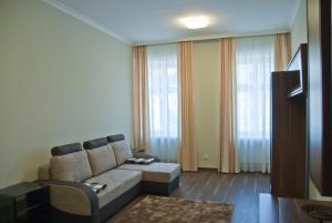 a living room with a couch and some windows at Apartman U Kolonady in Karlovy Vary