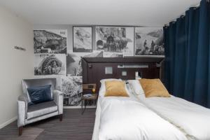 a bedroom with a bed and a chair at Svartisen Apartments in Glomfjord