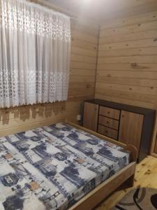 a bedroom with a bed and a window at Лукі in Svityazʼ