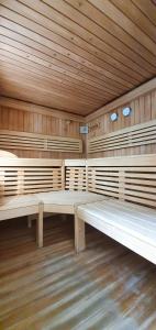 a large empty sauna with wooden walls and benches at SPA Barlinek, Hotel Alma MED & SPA in Barlinek