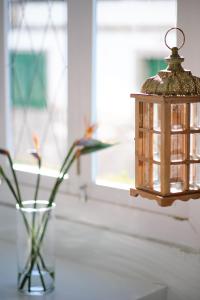 a lantern hanging from a window next to a vase at AVANTI Lifestyle Hotel - Only Adults in Corralejo