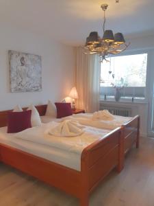 a large bed in a bedroom with a large window at Fewo Schneewittchen in Mittenwald