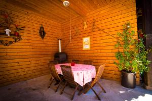 Au murier في Goxwiller: طاولة وكراسي في غرفة بجدار خشبي