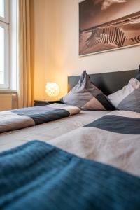 two beds in a room with a picture on the wall at Arbio I Cozy Apart in Leipzig center in Leipzig