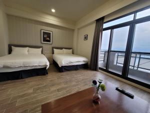En eller flere senger på et rom på 渡小夜電梯民宿 Yilannight B&B