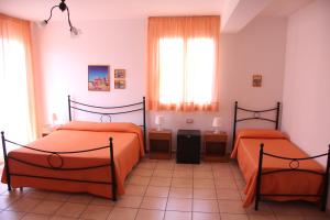A bed or beds in a room at Fragolina B&B