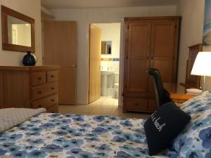 a bedroom with a bed and a bathroom at B2 Waterfoot Apartment in Newcastle