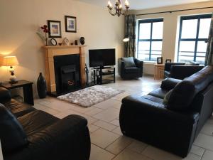 a living room with a couch and a fireplace at B2 Waterfoot Apartment in Newcastle
