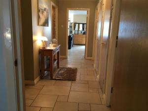 a hallway with a tiled floor in a house at B2 Waterfoot Apartment in Newcastle