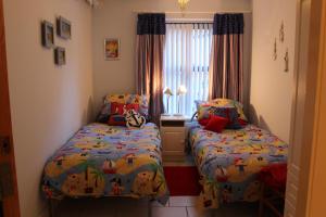 a bedroom with two beds and a window at B2 Waterfoot Apartment in Newcastle