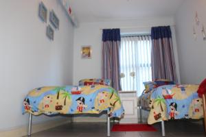 a bedroom with two beds and a window at B2 Waterfoot Apartment in Newcastle