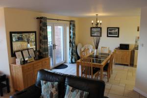 a living room with a couch and a table at B2 Waterfoot Apartment in Newcastle
