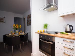 a kitchen with a table and a counter top at Beddoe Apartments Premier Lodge Eastleigh near Winchester and Southampton in Eastleigh