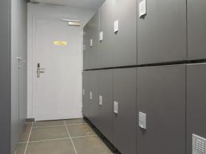 a hallway with a white door in a locker room at BE YOU LUXURY APART'HÔTEL - LA POUDRÉE in Paris