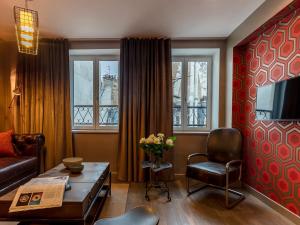 a living room with a couch and a table at BE YOU LUXURY APART'HÔTEL-LA GENTLE in Paris
