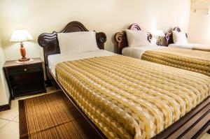 Postel nebo postele na pokoji v ubytování Hotel El Auca