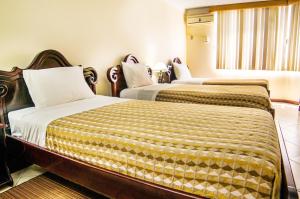 Postel nebo postele na pokoji v ubytování Hotel El Auca