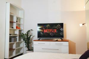 a tv sitting on top of a dresser in a bedroom at Apartments Bibic in Vodice