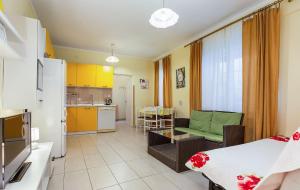 a room with a kitchen and a living room at Apartments and Rooms Lago Rupa in Rupa