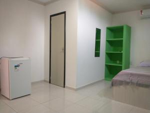 a room with a refrigerator and a bed in it at Pousada beira rio in Baía da Traição