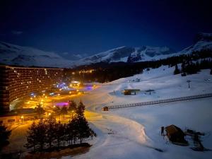 a ski resort in the snow at night at APPARTEMENT 804 in Le Dévoluy