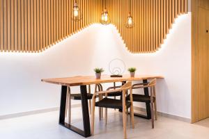a dining room with a wooden table and chairs at Sagitario Petit Ciutadella in Ciutadella