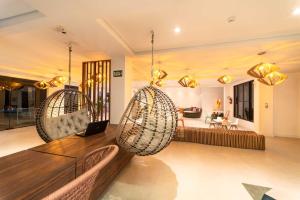 a living room with two hanging chairs and a couch at Rizzu Marina Hotel in Balneário Camboriú