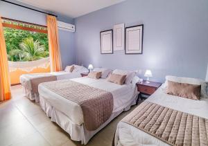 Un pat sau paturi într-o cameră la Hotel Eco Atlântico