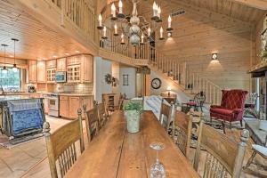 a large kitchen and dining room with a wooden table at Rustic and Modern Home with Fire Pit on Tower Pond! in Onaway