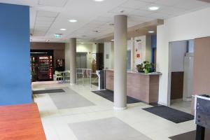 a lobby of a hospital with columns and a counter at Famulus Kollégium in Győr