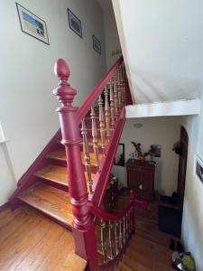 a staircase in a house with a red railing at Grüne Insel in Quedlinburg