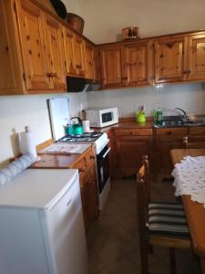 a kitchen with wooden cabinets and a white stove top oven at Casa Lella in Domaso