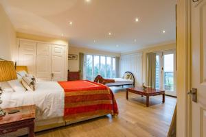a bedroom with a large bed and a living room at The Chestnuts by Bloom Stays in Canterbury