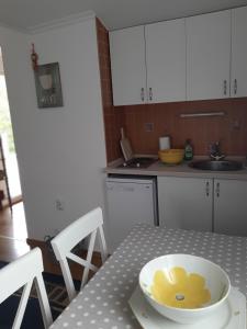 a bowl of food on a table in a kitchen at Apartmani Stipanic Tivat in Tivat