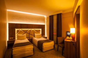 Postel nebo postele na pokoji v ubytování Rumi Hotel