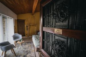 a room with a black door with a chair and a table at La Villa du Rhône in Miribel