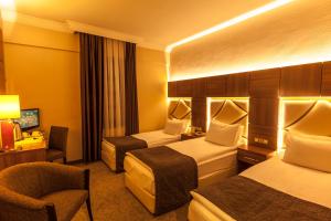 Postel nebo postele na pokoji v ubytování Rumi Hotel