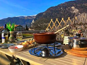 a grill with a pot on top of a table at Jobling's Holiday Apartment in Interlaken