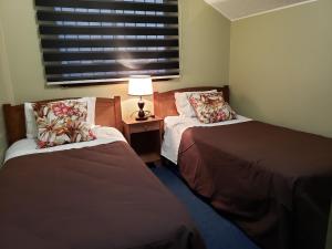 מיטה או מיטות בחדר ב-Casa Ohiggins