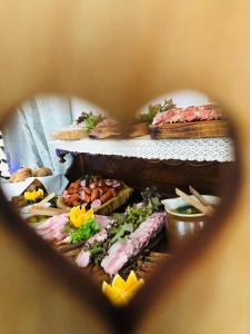 a wooden table topped with lots of food at Ostoja Morąg in Morąg