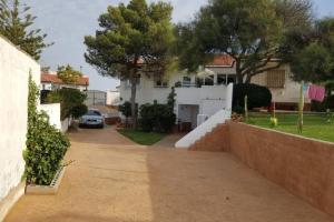 a driveway leading to a house with a yard at playa y naturaleza in Matalascañas +26 photos