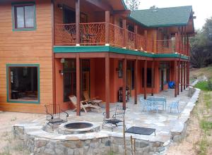 uma casa com um pátio e uma fogueira em frente em Sierra Trails Retreat em Mariposa