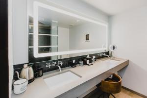 a bathroom with a sink and a mirror at The Maven at Dairy Block in Denver