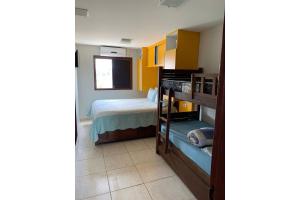a bedroom with a bed and a bunk bed at flat em serra negra - bezerros in Bezerros