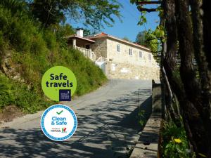 a sign on a road in front of a house at Quinta Labruja in Labruja