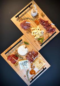 two cutting boards filled with different types of food at Chambres avec Jacuzzi privatif - Kassiopée Bed & Spa in Albi +20 photos