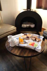 a tray of food on a table in front of a fireplace at Ashore Hotel in Seaside