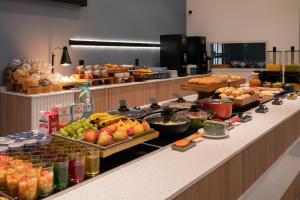 a buffet line with a lot of food on it at Slaviero Hotel Chapecó - Pet Friendly in Chapecó