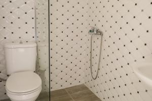 a bathroom with a toilet and a shower and a sink at La FLEUR apartments in Skiathos Town +17 photos