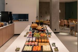 a long table with different types of food on it at Slaviero Hotel Chapecó - Pet Friendly in Chapecó